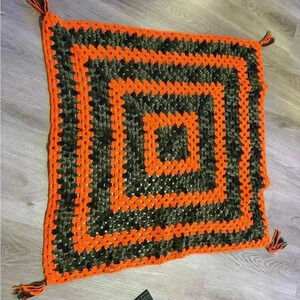 Handmade crocheted baby afghan blanket in orange & camo with tassels on corners